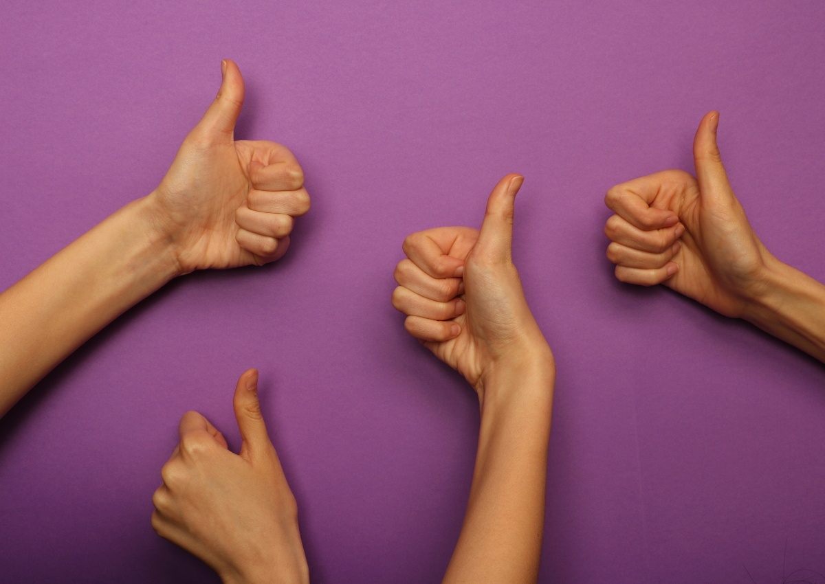 four hands giving a thumbs up good job